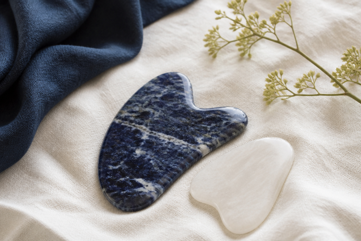 Smooth guasha stone tools on ivory linen